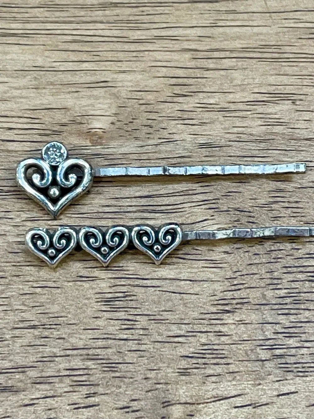 The Brighton Alcazar Heart Bobby Pin Set features two silver-plated hair pins